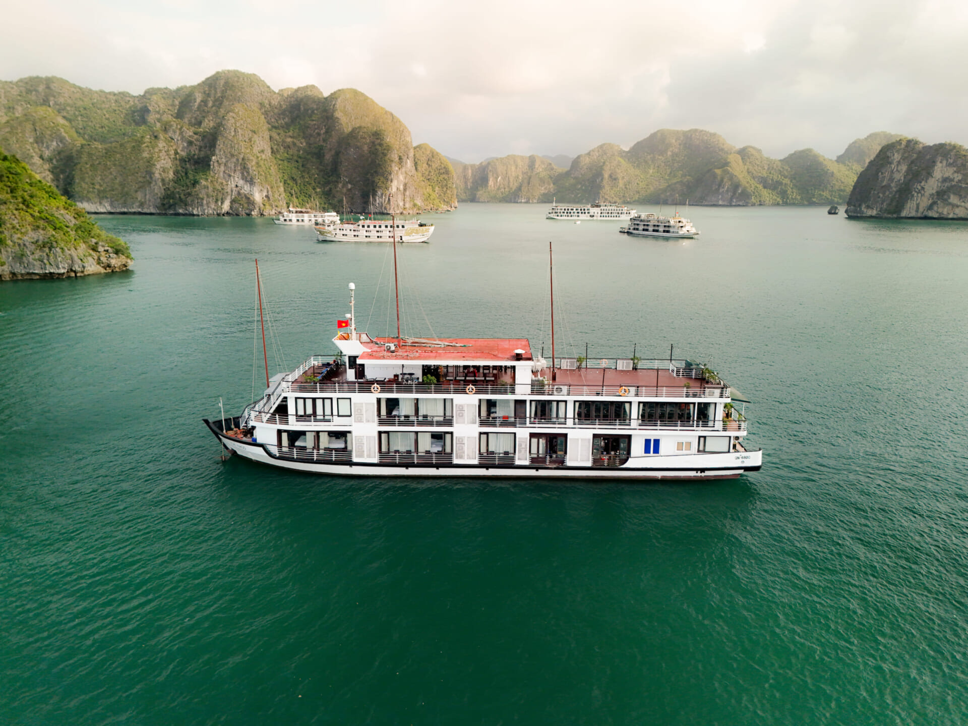 Milalux cruise ship anchored among limestone islands in Halong Bay