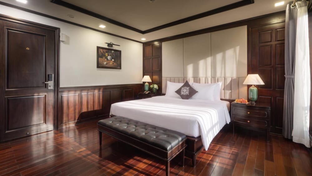 Mila Grand Junior Suite with king bed and dark wood interior