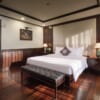 Mila Grand Junior Suite with king bed and dark wood interior