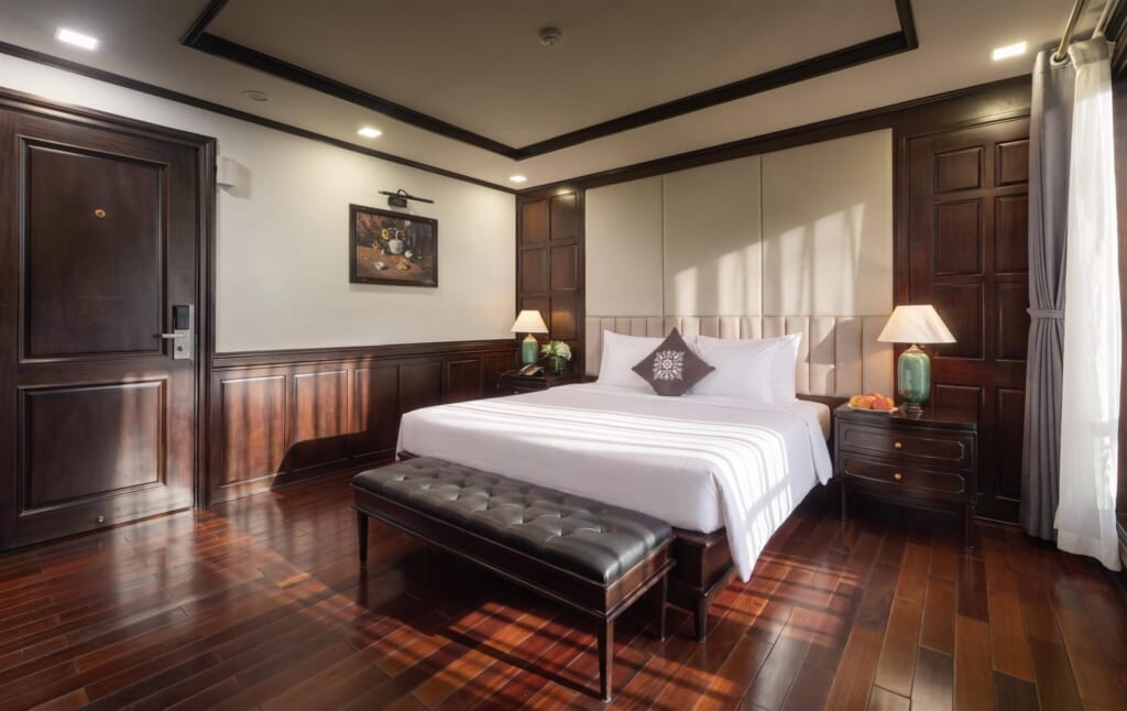 Mila Grand Junior Suite with king bed and dark wood interior
