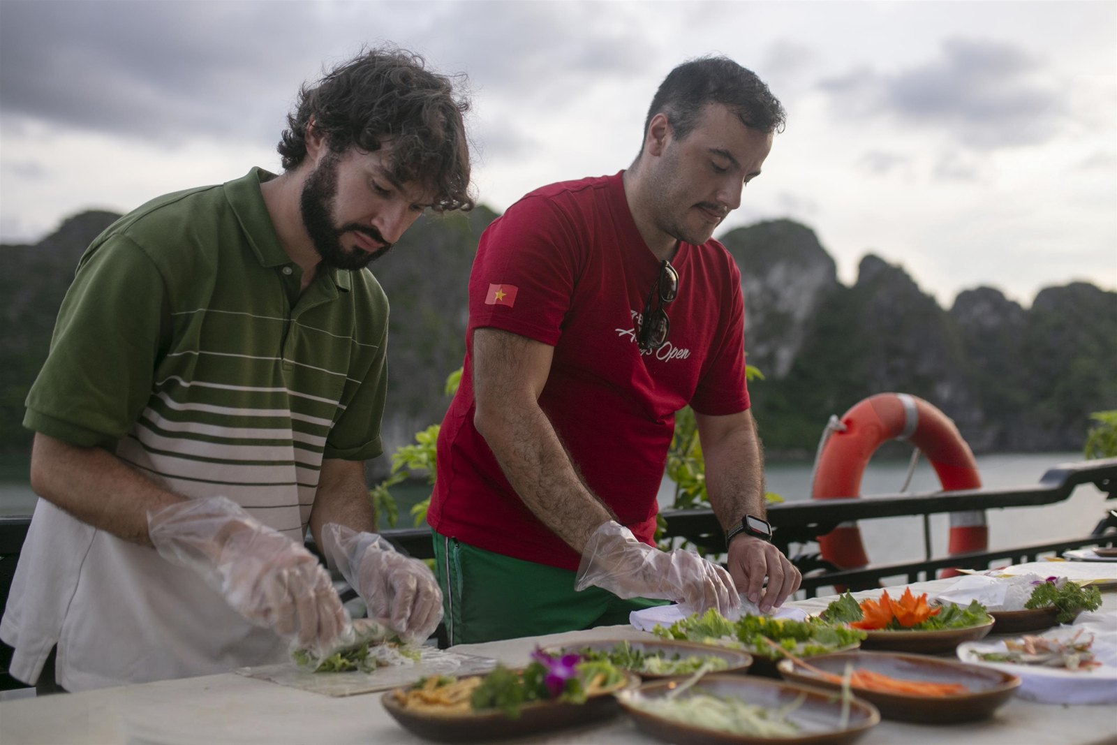 Guests learning to roll Vietnamese spring rolls with the chef on deck