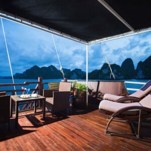 Royal Suite terrace with sun loungers at dusk on Halong Bay